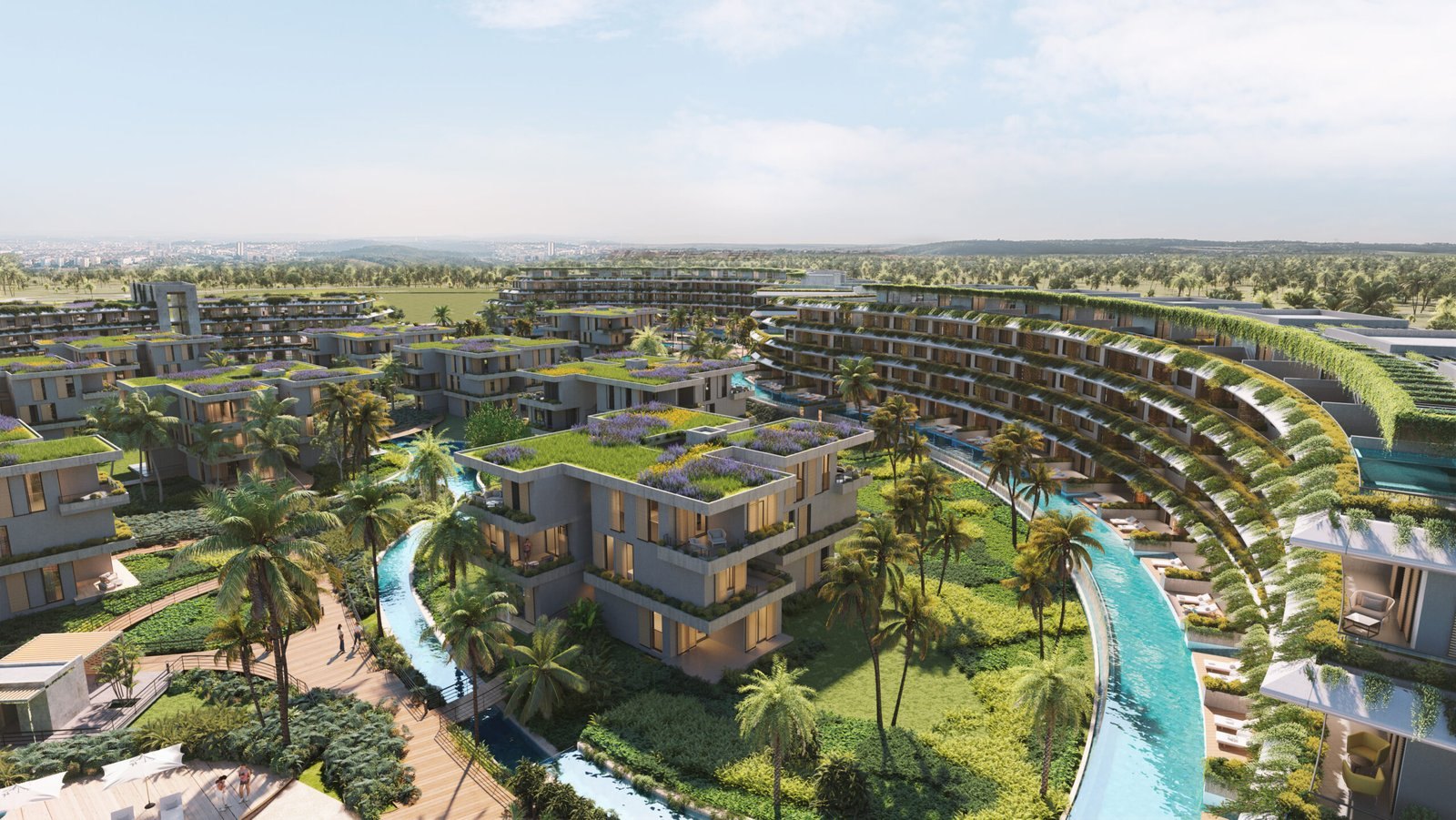 Aerial rendering of River Island in Punta Cana, looking over green-roofed residential blocks and a winding canal in a plan for 692 residences.